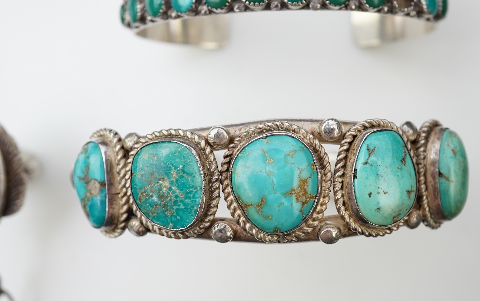 A collection of silver jewellery including a Zuni bangle